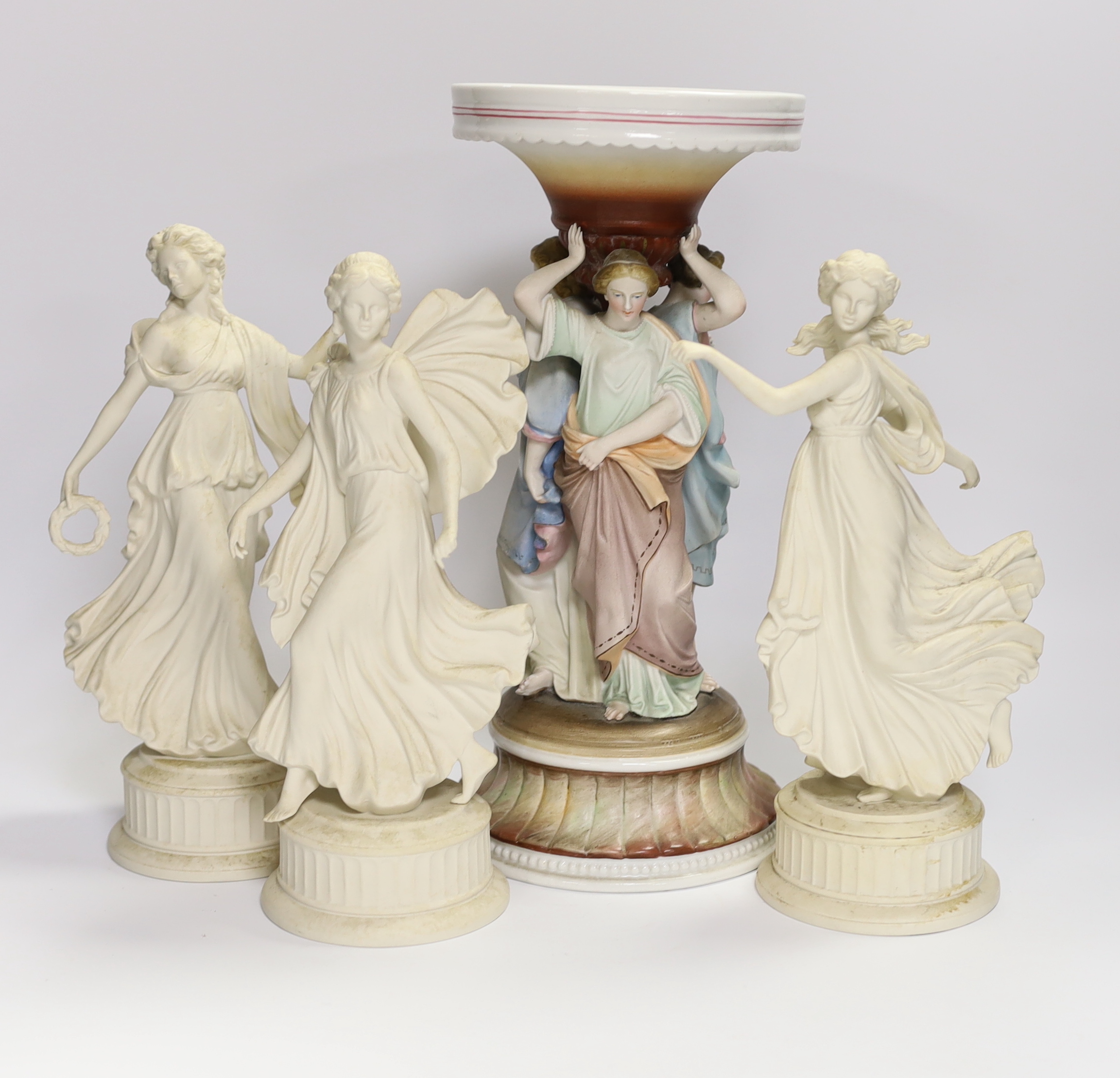 Three Wedgwood Dancing Hours figurines and a 19th century porcelain three graces centrepiece, largest 30cm high